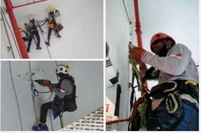 Rope access technician preparing equipment for work at height